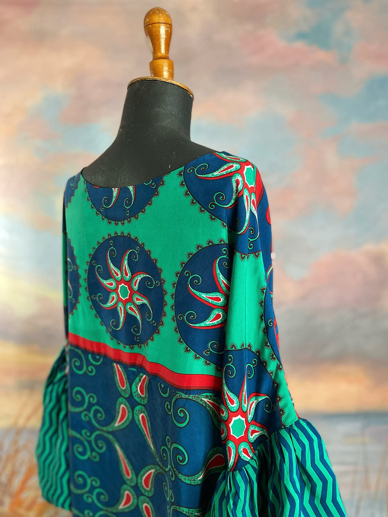 Silk crepe shift dress with pockets and volume long sleeves gathered in to fitted cuffs. Bold grphic print in shades of cobalt blue, teal and scarlet.  Unique garments sustainably created from vintage textiles by the Pavilion Parade studio.