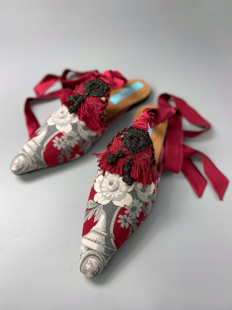 Grisaille classical motifs on crimson toile pointed toe shoes with black and grey Victorian tassel embellishment. Bohemian style sustainably created from antique textiles by the Pavilion Parade studio.
