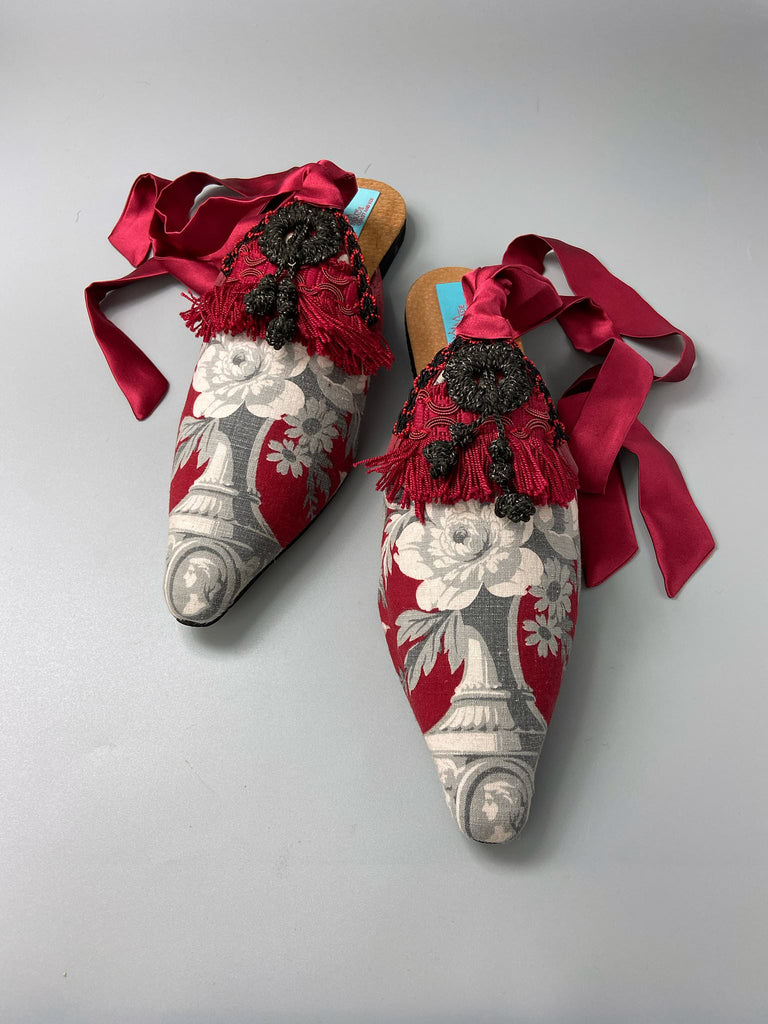 Grisaille classical motifs on crimson toile pointed toe shoes with black and grey Victorian tassel embellishment. Bohemian style sustainably created from antique textiles by the Pavilion Parade studio.