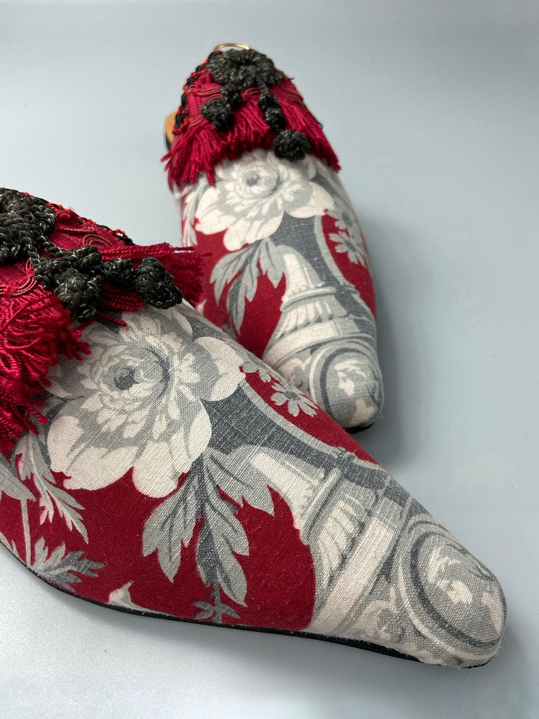 Grisaille classical motifs on crimson toile pointed toe shoes with black and grey Victorian tassel embellishment. Bohemian style sustainably created from antique textiles by the Pavilion Parade studio.
