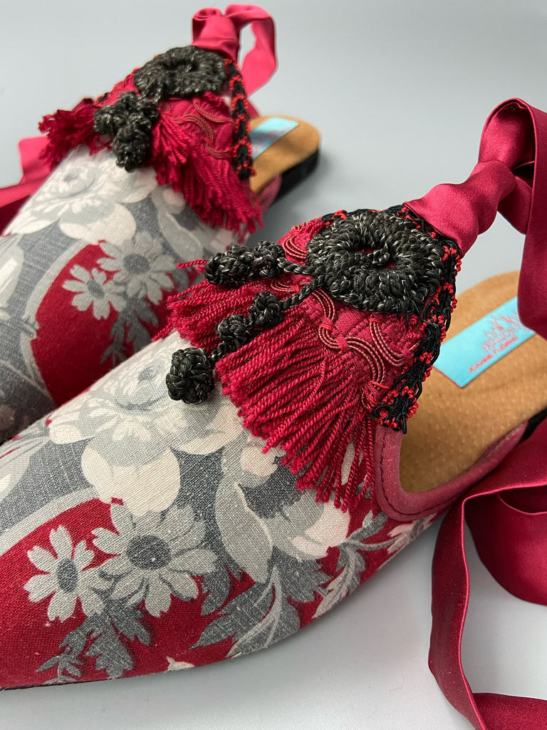 Grisaille classical motifs on crimson toile pointed toe shoes with black and grey Victorian tassel embellishment. Bohemian style sustainably created from antique textiles by the Pavilion Parade studio.