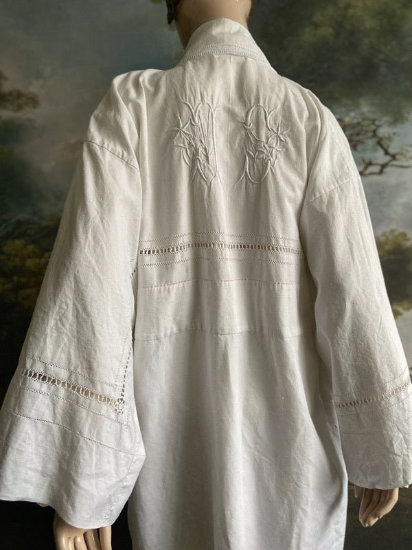 Full length kimono inspired robe with large patch pockets and wide sleeves. Created from an antique heavy French linen trousseau sheet with heirloom embroidery and drawn thread work. All French seamed with hand finished hems and collar. Bohemian styles sustainably created from antique and vintage textiles by the Pavilion Parade studio.
