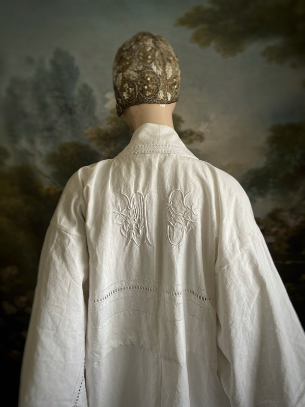 Full length kimono inspired robe with large patch pockets and wide sleeves. Created from an antique heavy French linen trousseau sheet with heirloom embroidery and drawn thread work. All French seamed with hand finished hems and collar. Bohemian styles sustainably created from antique and vintage textiles by the Pavilion Parade studio.
