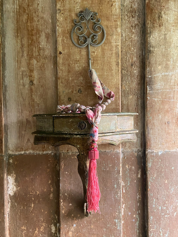 1920s style long silk sautoir necklace with antique tassel embellishment. Bohemian style from vintage textiles by Pavilion Parade. 