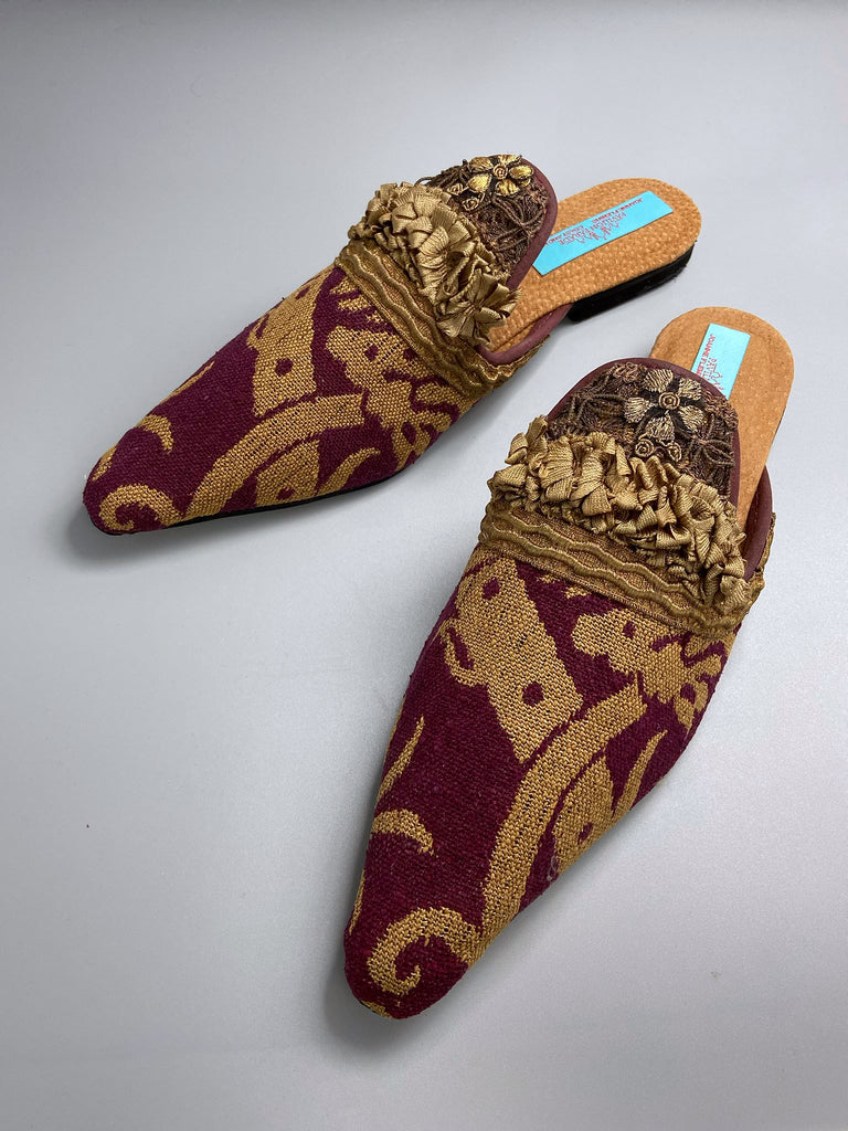 Wine red and old gold brocade open back mule shoes embellished with silk ribbon and metallic passementerie braid. Bohemian styles created from antique textiles by the Pavilion Parade studio.