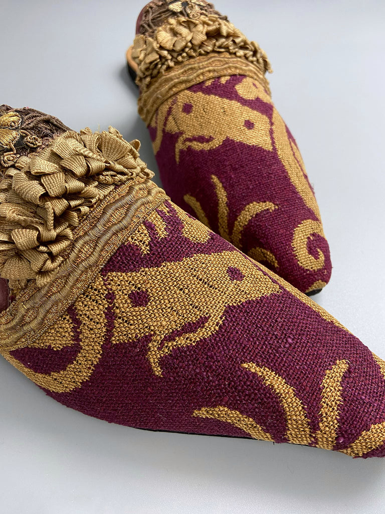 Wine red and old gold brocade open back mule shoes embellished with silk ribbon and metallic passementerie braid. Bohemian styles created from antique textiles by the Pavilion Parade studio.