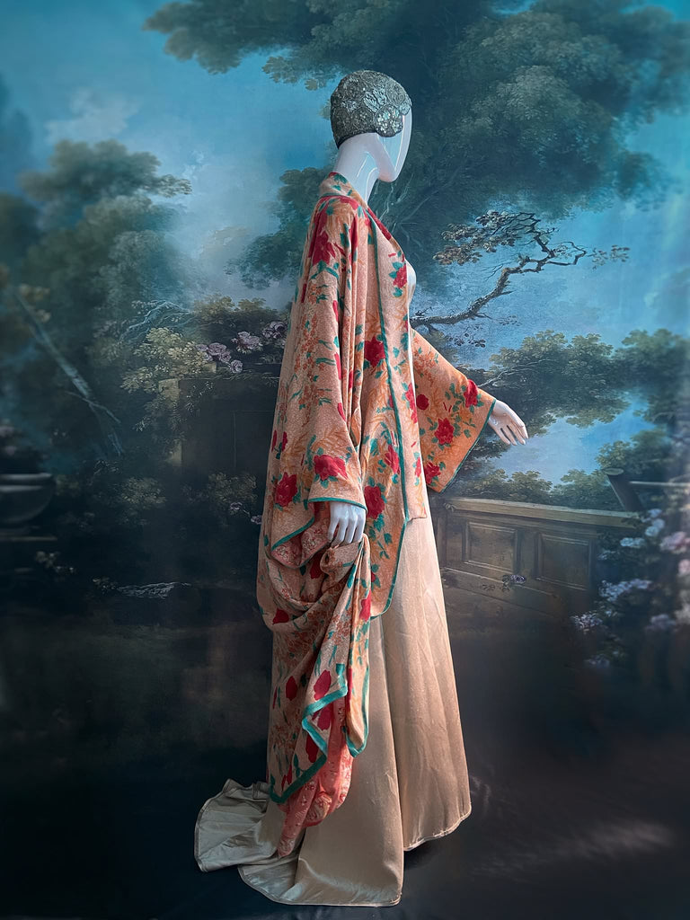 Full length 1920s 1930s Deco inspired kimono robe with large patch pockets. Newly created from a peach and mint green block print rose vintage silk crepe. Kimono collar and wide sleeves. Fully lined in silk with French seams throughout. Bohemian styles sustainably created from antique and vintage textiles by the Pavilion Parade studio.
