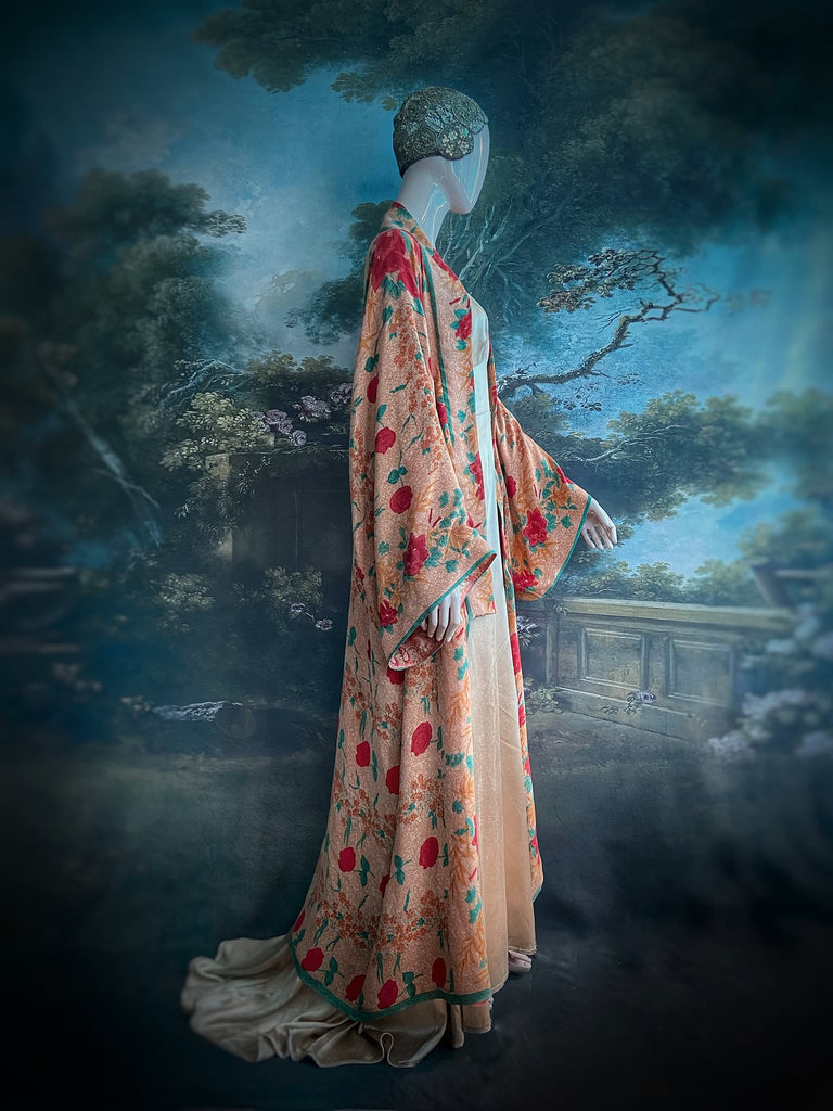 Full length 1920s 1930s Deco inspired kimono robe with large patch pockets. Newly created from a peach and mint green block print rose vintage silk crepe. Kimono collar and wide sleeves. Fully lined in silk with French seams throughout. Bohemian styles sustainably created from antique and vintage textiles by the Pavilion Parade studio.