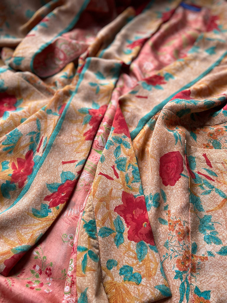 Full length 1920s 1930s Deco inspired kimono robe with large patch pockets. Newly created from a peach and mint green block print rose vintage silk crepe. Kimono collar and wide sleeves. Fully lined in silk with French seams throughout. Bohemian styles sustainably created from antique and vintage textiles by the Pavilion Parade studio.