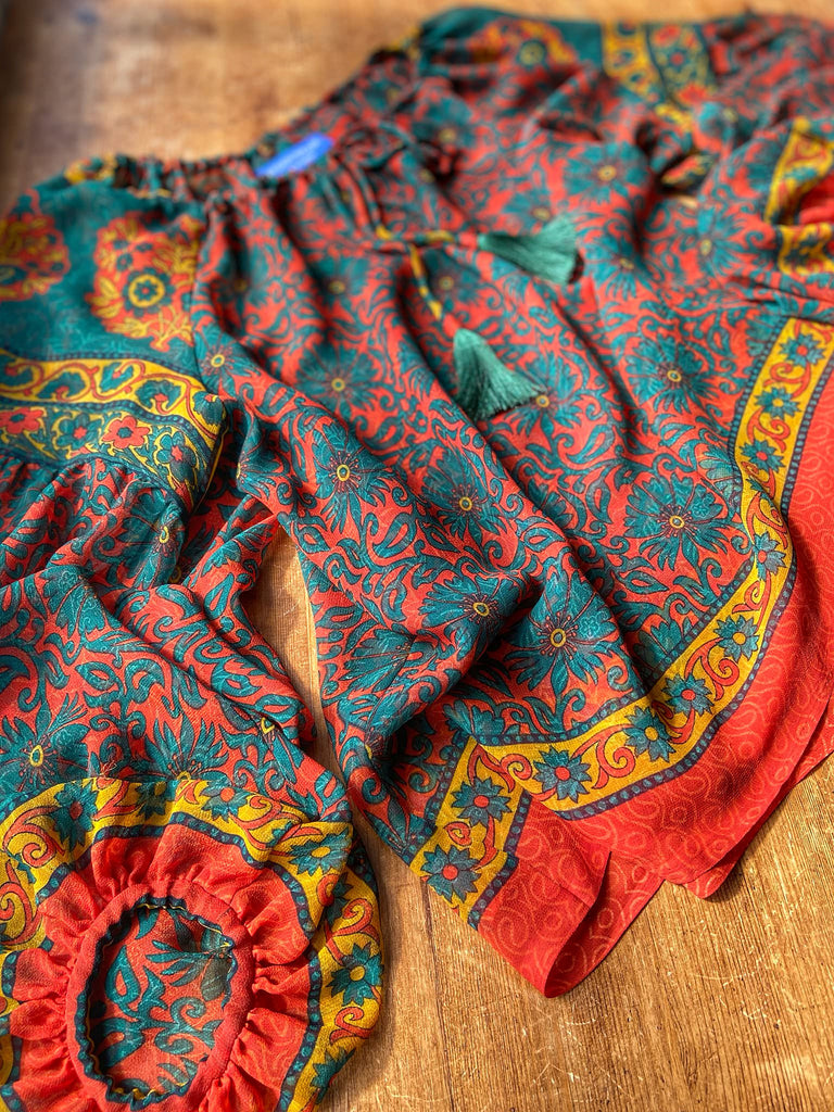Emerald, paprika and sunflower yellow silk georgette blouse with long full sleeves and adjustable drawstring neckline. Bohemian styles sustainably created from antique and vintage textiles by the Pavilion Parade studio. 