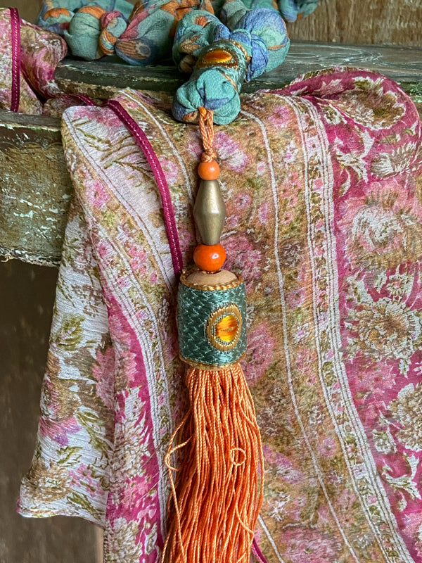 1920s style long silk sautoir necklace with antique tassel embellishment. Bohemian style from vintage textiles by Pavilion Parade. 