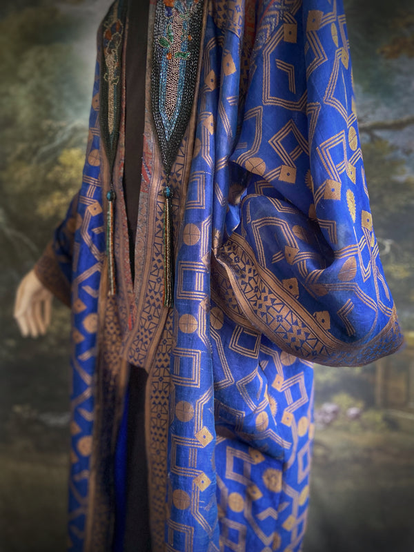 Egyptian Revival 1920s inspired full length robe created from vintage and antique textiles. Lapiz lazuli blue and metallic bronze-gold silk brocade. Lined in block printed silk with design of ancient Egyptian figures, pyramids, chariots. Bohemian style from Pavilion Parade.