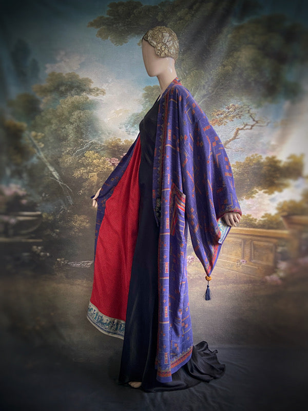 Egyptian Revival 1920s inspired full length robe created from vintage and antique textiles. Lapiz lazuli blue and scarlet silk crepe. Lined in block printed silk with design of ancient Egyptian figures, pyramids, chariots. Bohemian style from Pavilion Parade.