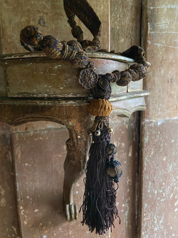 1920s style long silk sautoir necklace with antique tassel embellishment. Bohemian style from vintage textiles by Pavilion Parade. 