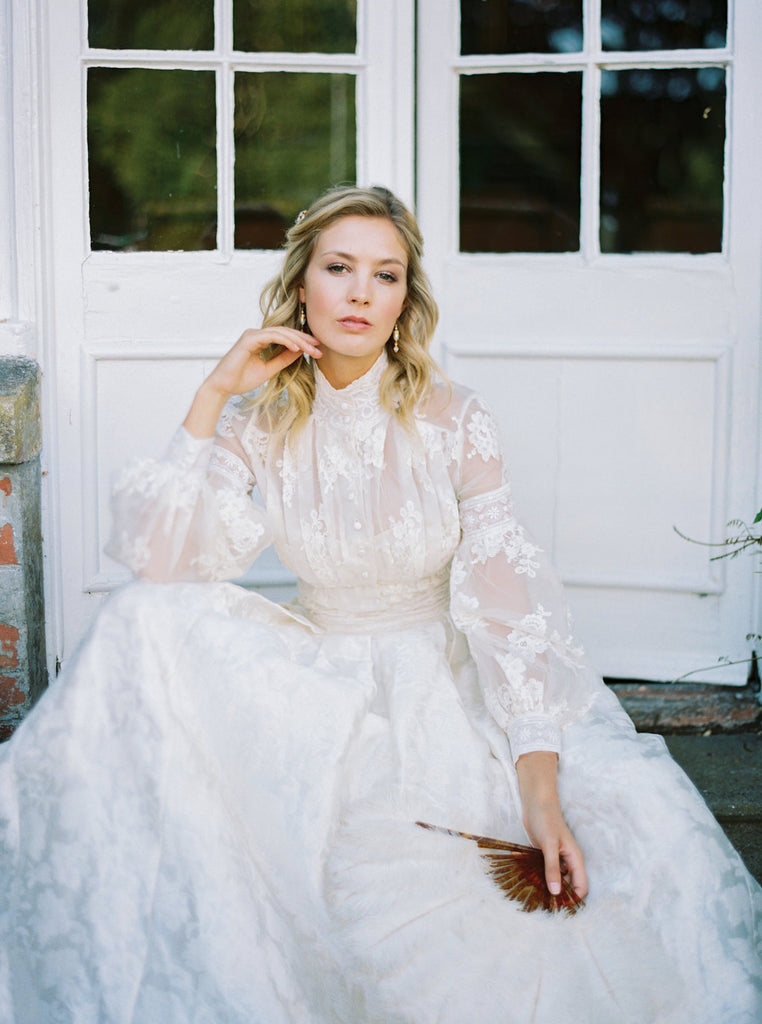 Ivory French lace and silk organza fitted romantic blouse. Antique lace elements at high fitted collar and cuffs. Full bishop sleeves and pleated bodice front. A flight of fancy from the Pavilion Parade studio. Photo by Mariel Hannah.