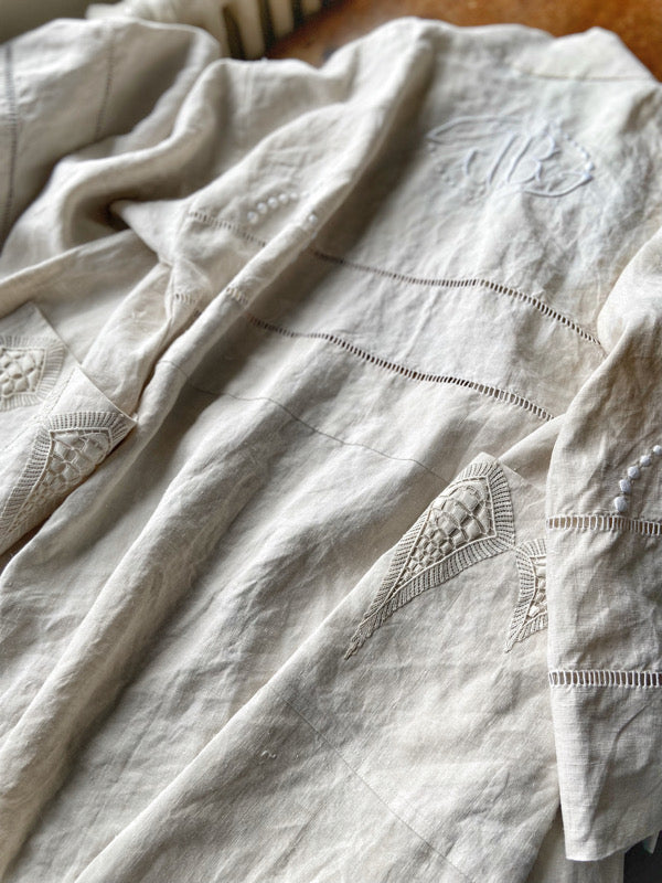 Full length kimono inspired robe with large patch pockets and wide sleeves. Created from an antique heavy French linen trousseau sheet with heirloom embroidery and drawn thread work. All French seamed with hand finished hems and collar. Bohemian styles sustainably created from antique and vintage textiles by the Pavilion Parade studio.