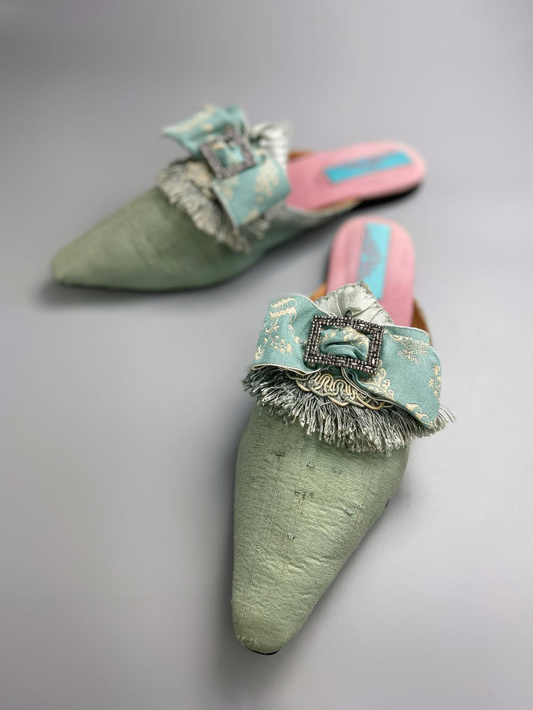 Eau de Nil silk pointed toe shoes in the  Georgian style. Embellished with silk ribbon bows and cut steel antique buckles. Bohemian styles sustainably created from antique textiles by Pavilion Parade.