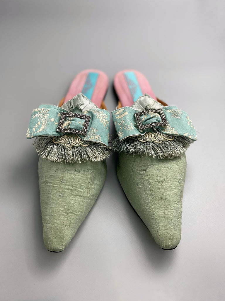 Eau de Nil silk pointed toe shoes in the  Georgian style. Embellished with silk ribbon bows and cut steel antique buckles. Bohemian styles sustainably created from antique textiles by Pavilion Parade.