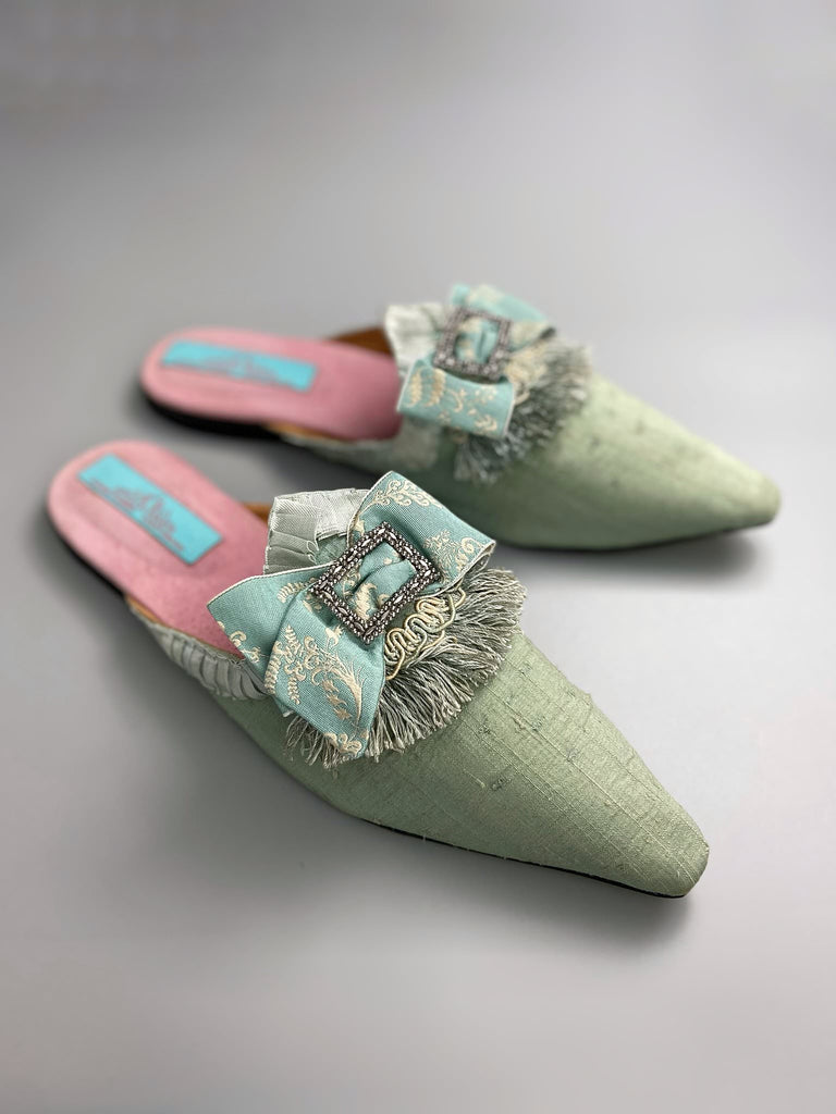 Eau de Nil silk pointed toe shoes in the  Georgian style. Embellished with silk ribbon bows and cut steel antique buckles. Bohemian styles sustainably created from antique textiles by Pavilion Parade.