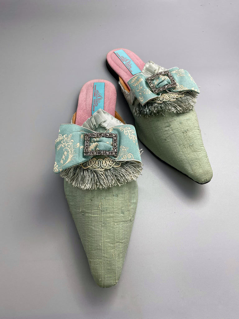 Eau de Nil silk pointed toe shoes in the  Georgian style. Embellished with silk ribbon bows and cut steel antique buckles. Bohemian styles sustainably created from antique textiles by Pavilion Parade.