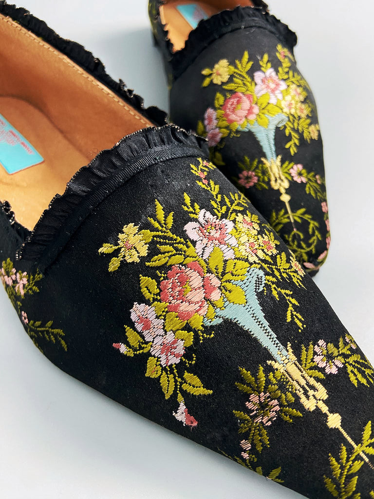 Black silk regency slipper shoes with floral embroidered posy motif.  Pointed toes and black silk satin ankle ribbons. Bohemian style created from antique textiles by the Pavilion Parade studio.