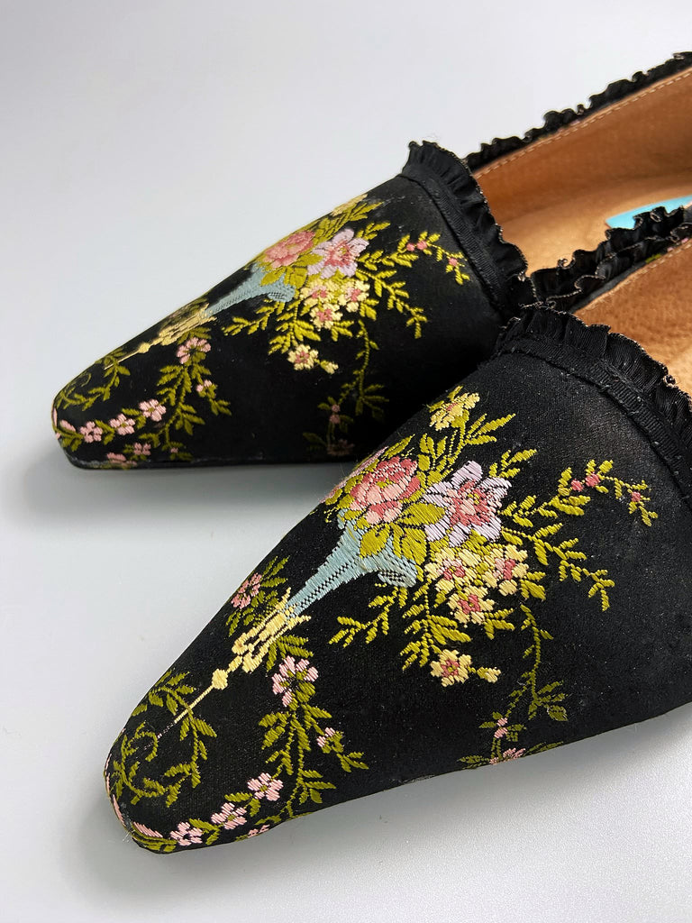 Black silk regency slipper shoes with floral embroidered posy motif.  Pointed toes and black silk satin ankle ribbons. Bohemian style created from antique textiles by the Pavilion Parade studio.