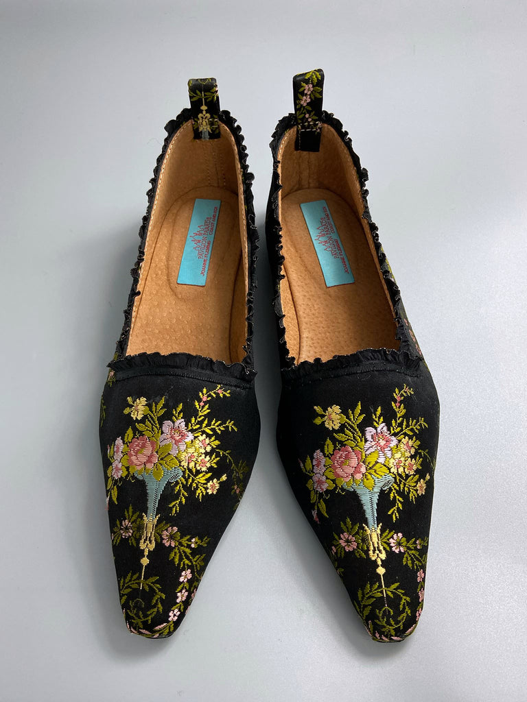 Black silk regency slipper shoes with floral embroidered posy motif.  Pointed toes and black silk satin ankle ribbons. Bohemian style created from antique textiles by the Pavilion Parade studio.