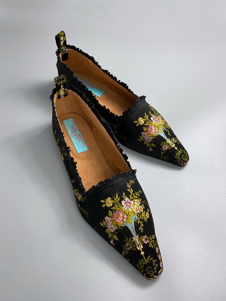 Black silk regency slipper shoes with floral embroidered posy motif.  Pointed toes and black silk satin ankle ribbons. Bohemian style created from antique textiles by the Pavilion Parade studio.