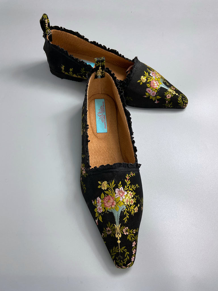 Black silk regency slipper shoes with floral embroidered posy motif.  Pointed toes and black silk satin ankle ribbons. Bohemian style created from antique textiles by the Pavilion Parade studio.