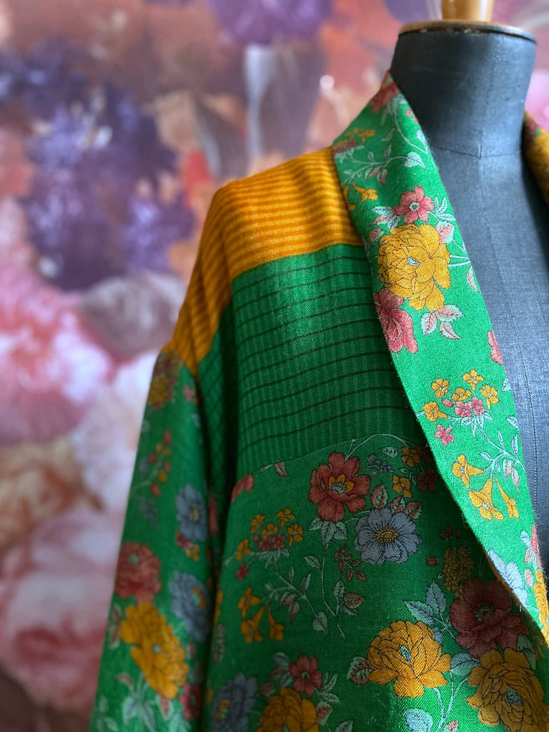Emerald green and saffron yellow floral fine wool robe with silk lining. Wide sleeves, deep pockets and tassel sash. Unique bohemian style created from vintage and antique textiles by the Pavilion Parade studio.