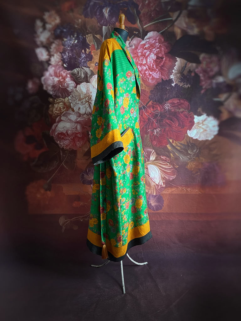 Emerald green and saffron yellow floral fine wool robe with silk lining. Wide sleeves, deep pockets and tassel sash. Unique bohemian style created from vintage and antique textiles by the Pavilion Parade studio.