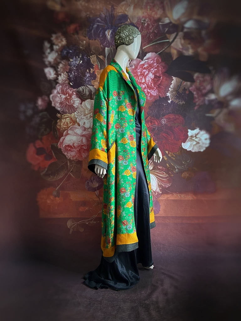 Emerald green and saffron yellow floral fine wool robe with silk lining. Wide sleeves, deep pockets and tassel sash. Unique bohemian style created from vintage and antique textiles by the Pavilion Parade studio.