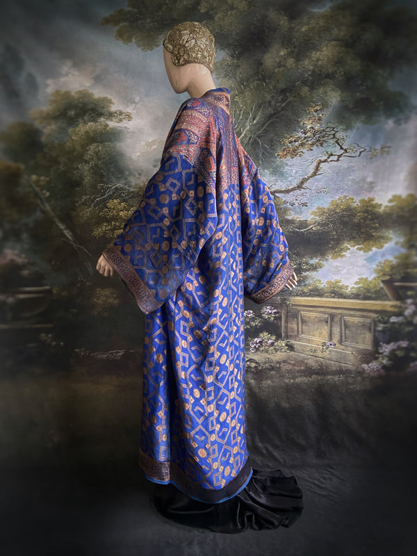 Egyptian Revival 1920s inspired full length robe created from vintage and antique textiles. Lapiz lazuli blue and metallic bronze-gold silk brocade. Lined in block printed silk with design of ancient Egyptian figures, pyramids, chariots. Bohemian style from Pavilion Parade.