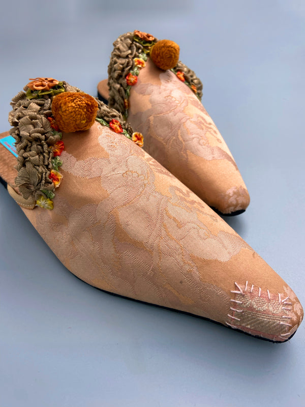 Apricot silk damask cherub shoes with pompom tassels, sustainably created from antique textiles by the Pavilion Parade studio