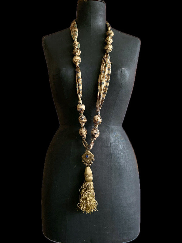 1920s style long silk sautoir necklace with antique tassel embellishment. Bohemian style from vintage textiles by Pavilion Parade. 