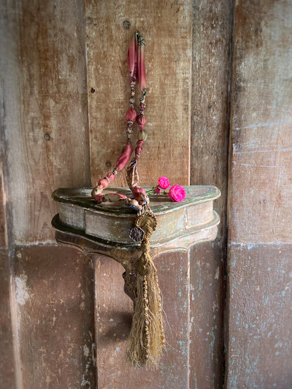 1920s style long silk sautoir necklace with antique tassel embellishment. Bohemian style from vintage textiles by Pavilion Parade. 