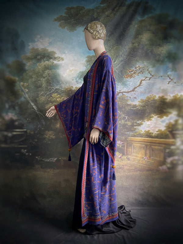 Egyptian Revival 1920s inspired full length robe created from vintage and antique textiles. Lapiz lazuli blue and scarlet silk crepe. Lined in block printed silk with design of ancient Egyptian figures, pyramids, chariots. Bohemian style from Pavilion Parade.