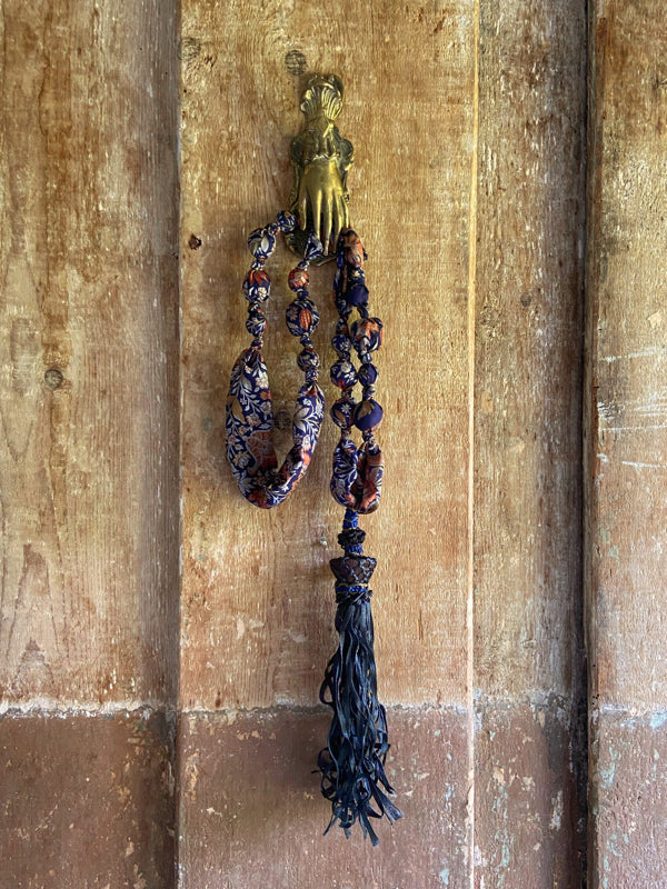1920s style long silk sautoir necklace with antique tassel embellishment. Bohemian style from vintage textiles by Pavilion Parade. 