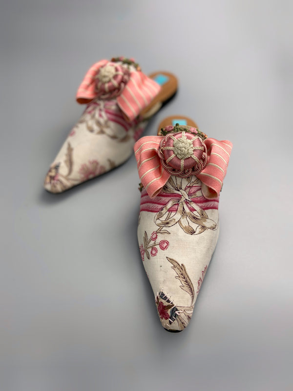 Marie Antoinette inspired shoes created from antique early 1800s rose pink and ivory block printed French cotton toile and embellished with pink silk passementerie rosettes. Bohemian style from the Pavilion Parade studio.