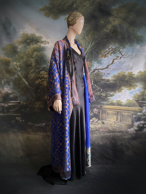Egyptian Revival 1920s inspired full length robe created from vintage and antique textiles. Lapiz lazuli blue and metallic bronze-gold silk brocade. Lined in block printed silk with design of ancient Egyptian figures, pyramids, chariots. Bohemian style from Pavilion Parade.