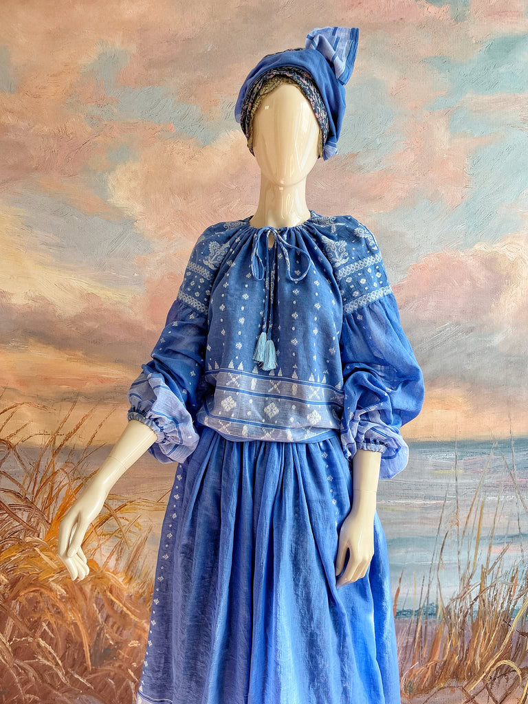 Fine soft pure cotton weave in a fresh sky blue and white palette. Full sleeved faded indigo peasant blouse and full dirndl skirt. Bohemian styles created from vintage textiles by Pavilion parade studio. 