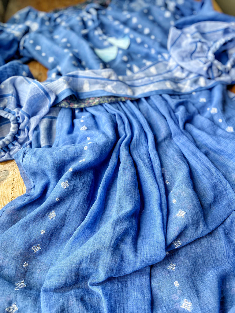 Fine soft pure cotton weave in a fresh sky blue and white palette. Full sleeved faded indigo peasant blouse and full dirndl skirt. Bohemian styles created from vintage textiles by Pavilion parade studio. 