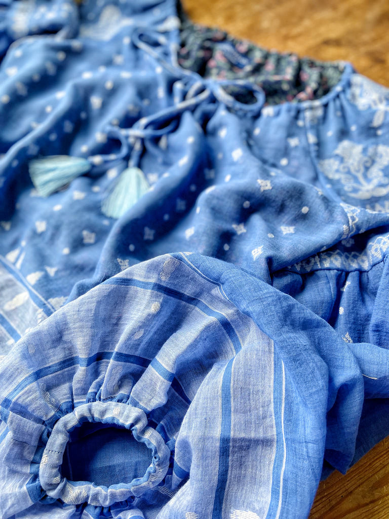 Fine soft pure cotton weave in a fresh sky blue and white palette. Full sleeved faded indigo peasant blouse and full dirndl skirt. Bohemian styles created from vintage textiles by Pavilion parade studio. 