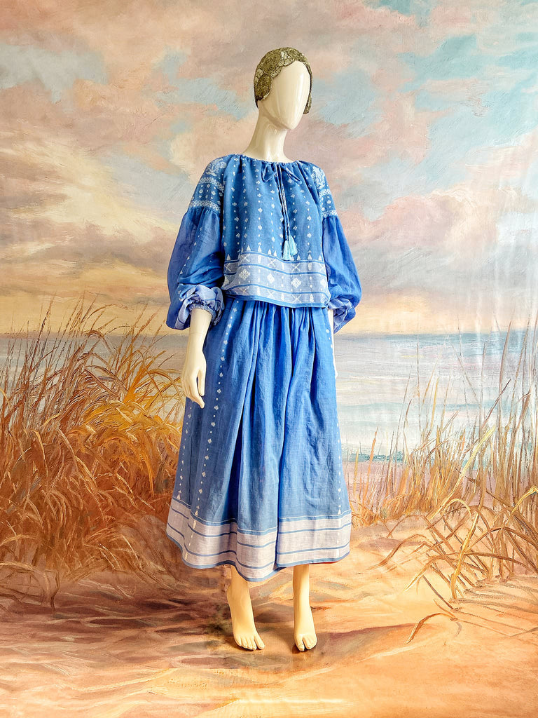 Fine soft pure cotton weave in a fresh sky blue and white palette. Full sleeved faded indigo peasant blouse and full dirndl skirt. Bohemian styles created from vintage textiles by Pavilion parade studio. 