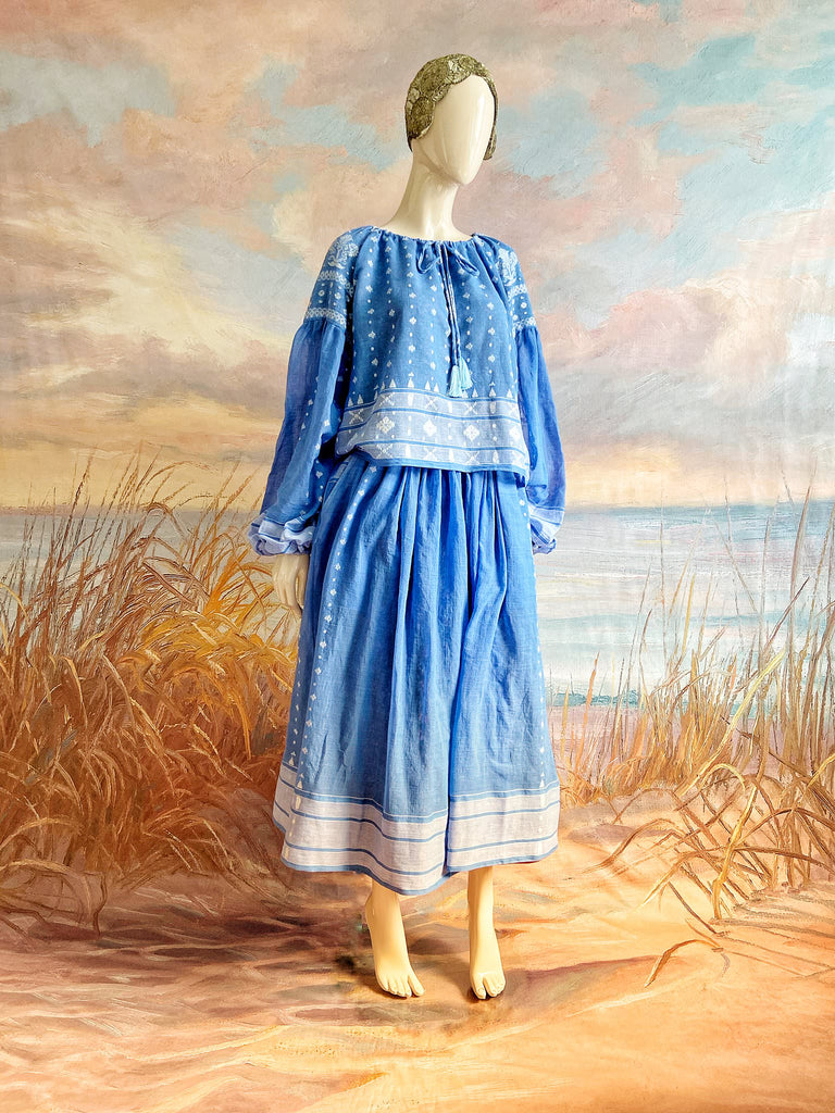 Fine soft pure cotton weave in a fresh sky blue and white palette. Full sleeved faded indigo peasant blouse and full dirndl skirt. Bohemian styles created from vintage textiles by Pavilion parade studio. 