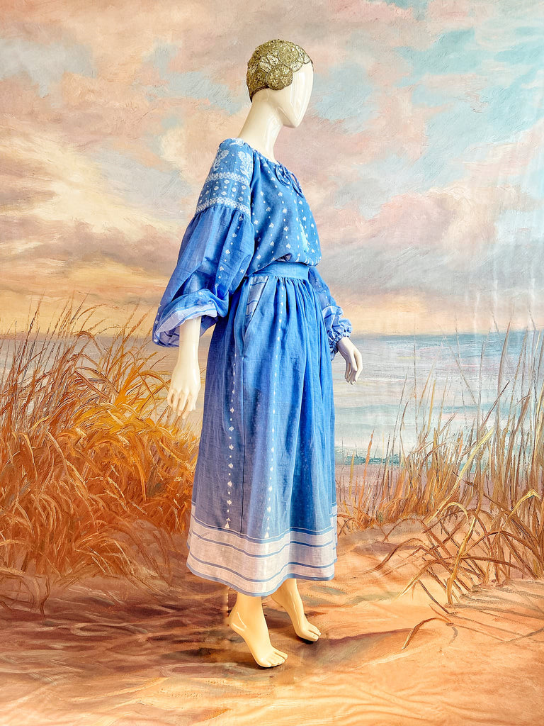 Fine soft pure cotton weave in a fresh sky blue and white palette. Full sleeved faded indigo peasant blouse and full dirndl skirt. Bohemian styles created from vintage textiles by Pavilion parade studio. 