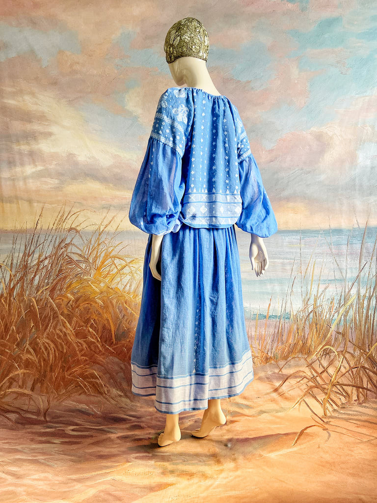 Fine soft pure cotton weave in a fresh sky blue and white palette. Full sleeved faded indigo peasant blouse and full dirndl skirt. Bohemian styles created from vintage textiles by Pavilion parade studio. 