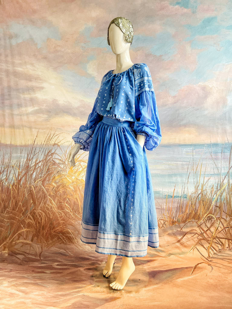Fine soft pure cotton weave in a fresh sky blue and white palette. Full sleeved faded indigo peasant blouse and full dirndl skirt. Bohemian styles created from vintage textiles by Pavilion parade studio. 