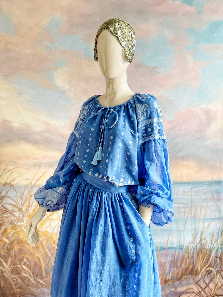 Fine soft pure cotton weave in a fresh sky blue and white palette. Full sleeved faded indigo peasant blouse and full dirndl skirt. Bohemian styles created from vintage textiles by Pavilion parade studio. 