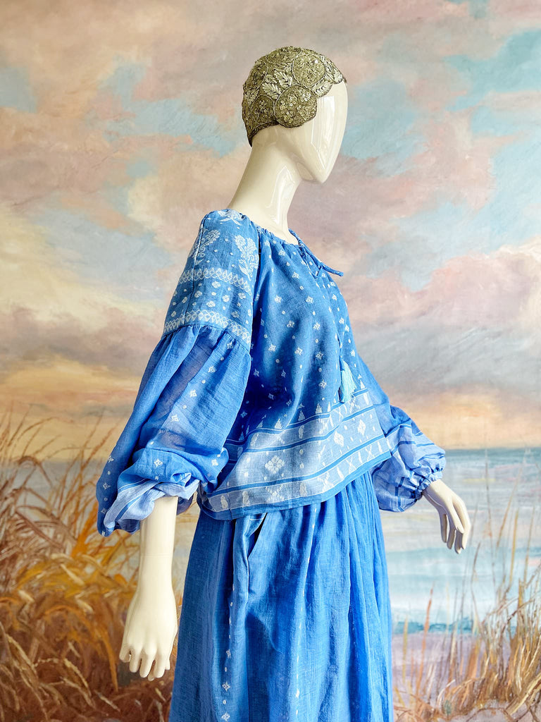 Fine soft pure cotton weave in a fresh sky blue and white palette. Full sleeved faded indigo peasant blouse and full dirndl skirt. Bohemian styles created from vintage textiles by Pavilion parade studio. 